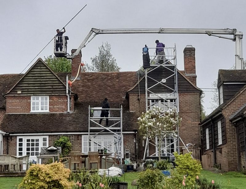 The Roof Moss Cleaners using cherry picker and scaffolding to clean roof safely and professionally in Desborough, Northamptonshire