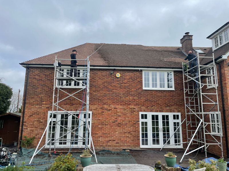 Roof cleaning carried out safely from scaffold towers by The Roof Moss Cleaners in Desborough